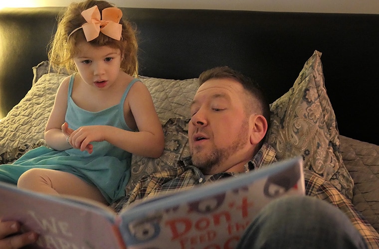 Noah Solomon reading aloud to daughter Anabel