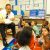 Harold Jones, a paralegal specialist and diversity officer at Navy Medicine Support Command, reads to first-grade students at Timucuan Elementary School as part of a Navy Medicine Support Command-sponsored community service volunteer program at the school. (U.S. Navy photo by Mass Communication Specialist 1st Class Bruce Cummins/Released)